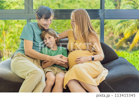 Cozy family time at home as pregnant mom, dad, and son enjoy shared moments on the sofa, creating heartwarming memories and cherishing their time together Cozy family time at home as pregnant mom, dad, and son enjoy shared moments on the sofa, creating heartwarming memories and cherishing their time together 113415345