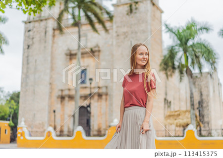 Woman tourist explores the vibrant streets of Valladolid, Mexico, immersing herself in the rich culture and colorful architecture of this charming colonial town 113415375