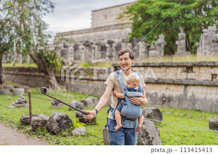Father and son tourists observing the old pyramid and temple of the castle of the Mayan architecture known as Chichen Itza these are the ruins of this ancient pre-columbian civilization and part of Father and son tourists observing the old pyramid and temple of the castle of the Mayan architecture known as Chichen Itza these are the ruins of this ancient pre-columbian civilization and part of 113415413