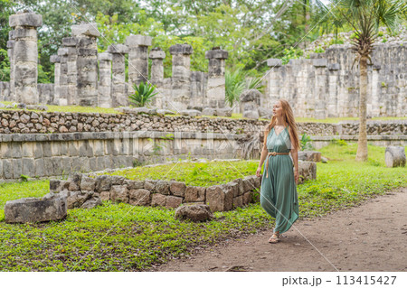 Beautiful tourist woman observing the old pyramid and temple of the castle of the Mayan architecture known as Chichen Itza these are the ruins of this ancient pre-columbian civilization and part of 113415427