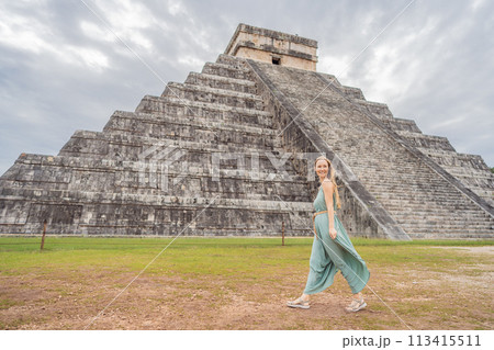 Beautiful tourist woman observing the old pyramid and temple of the castle of the Mayan architecture known as Chichen Itza these are the ruins of this ancient pre-columbian civilization and part of Beautiful tourist woman observing the old pyramid and temple of the castle of the Mayan architecture known as Chichen Itza these are the ruins of this ancient pre-columbian civilization and part of 113415511