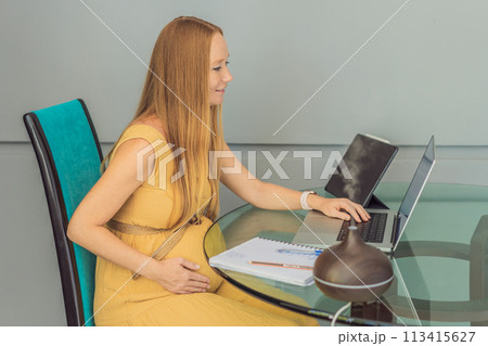 Expectant woman enhances work environment, using an aroma diffuser for a soothing atmosphere during pregnancy Expectant woman enhances work environment, using an aroma diffuser for a soothing atmosphere during pregnancy 113415627