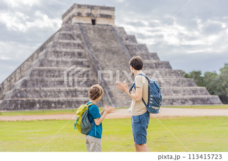 Father and son tourists observing the old pyramid and temple of the castle of the Mayan architecture known as Chichen Itza these are the ruins of this ancient pre-columbian civilization and part of 113415723