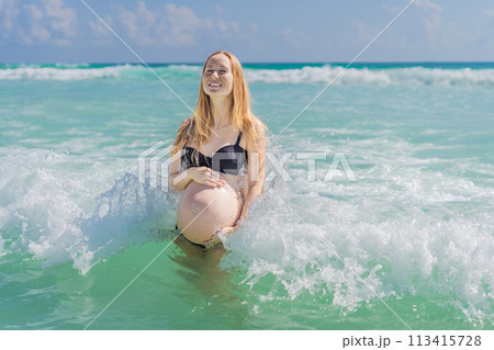 In the idyllic embrace of the Caribbean Sea, a pregnant woman finds bliss, savoring the warmth and serenity of the tropical waters during her pregnancy 113415728