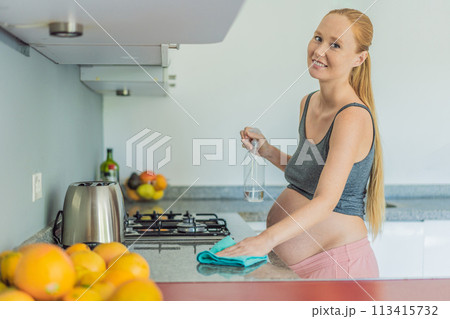 Efficient and dedicated, a pregnant woman tackles kitchen chores, ensuring a clean and organized space, exemplifying resilience and care during her pregnancy 113415732