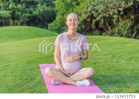 Energetic pregnant woman takes her workout outdoors, using an exercise mat for a refreshing and health-conscious outdoor exercise session Energetic pregnant woman takes her workout outdoors, using an exercise mat for a refreshing and health-conscious outdoor exercise session 113415753