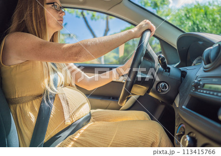 Pregnant woman driving with safety belt on in the car. Confident and capable, a pregnant woman takes the wheel, driving with care and determination as she navigates the journey of motherhood Pregnant woman driving with safety belt on in the car. Confident and capable, a pregnant woman takes the wheel, driving with care and determination as she navigates the journey of motherhood 113415766