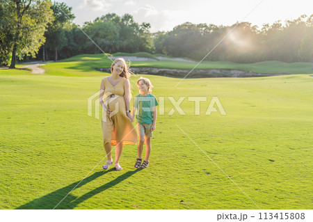 Heartwarming outdoor bonding as a pregnant mom and her son enjoy quality time together, savoring the beauty of nature and creating cherished moments Heartwarming outdoor bonding as a pregnant mom and her son enjoy quality time together, savoring the beauty of nature and creating cherished moments 113415808