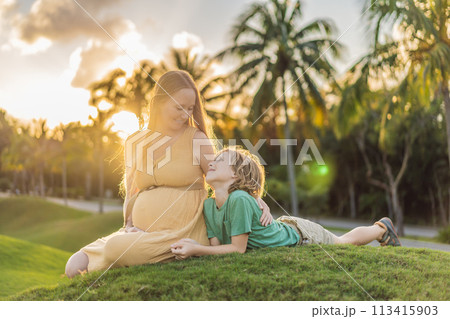 Heartwarming outdoor bonding as a pregnant mom and her son enjoy quality time together, savoring the beauty of nature and creating cherished moments Heartwarming outdoor bonding as a pregnant mom and her son enjoy quality time together, savoring the beauty of nature and creating cherished moments 113415903
