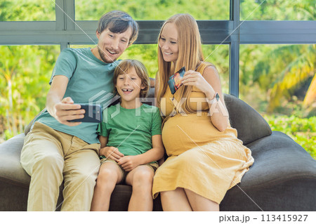 Heartwarming family video call as expecting mom, dad, and son share the excitement, displaying ultrasound photos and connecting virtually during the pregnancy journey Heartwarming family video call as expecting mom, dad, and son share the excitement, displaying ultrasound photos and connecting virtually during the pregnancy journey 113415927