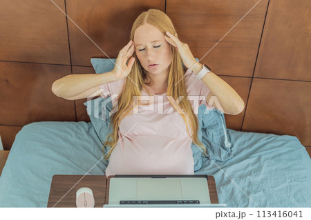 Weary pregnant woman, tired of working from home, navigates the challenges of balancing professional tasks with pregnancy demands Weary pregnant woman, tired of working from home, navigates the challenges of balancing professional tasks with pregnancy demands 113416041