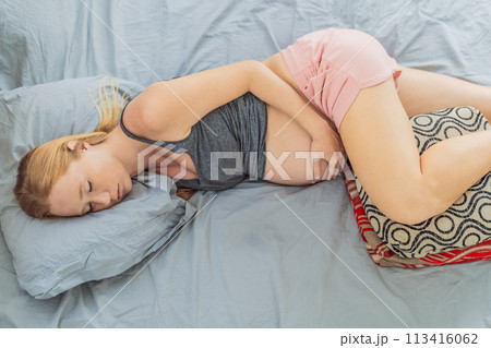 Sleep-deprived pregnant woman struggles with insomnia, navigating the challenges of restlessness during pregnancy 113416062