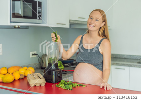 Embracing a nutritious choice, a pregnant woman joyfully prepares a vibrant vegetable smoothie, prioritizing wholesome ingredients for optimal well-being during her maternity journey Embracing a nutritious choice, a pregnant woman joyfully prepares a vibrant vegetable smoothie, prioritizing wholesome ingredients for optimal well-being during her maternity journey 113416152