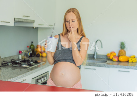 Happy pregnant young woman eating ice cream 113416209