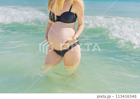 In the idyllic embrace of the Caribbean Sea, a pregnant woman finds bliss, savoring the warmth and serenity of the tropical waters during her pregnancy 113416348