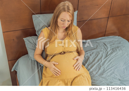 Expectant woman experiences discomfort, feeling unwell during pregnancy 113416436