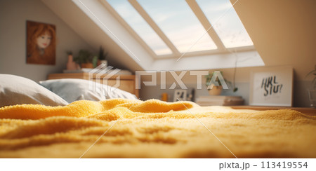 Bed with yellow blanket in attic bedroom. 113419554