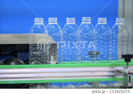 The  empty drinking water bottles  on the conveyor belt for filling process. 113420253