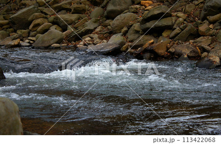 Rivulet on a small mountain river running between rocky shores Rivulet on a small mountain river running between rocky shores 113422068