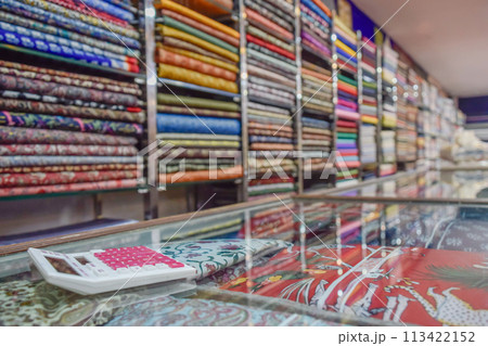 Calculator in textile business showing small manufacturer, market and economy 113422152