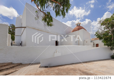 Puig de Missa architecture: white walls, terracotta dome, lush greenery 113422874