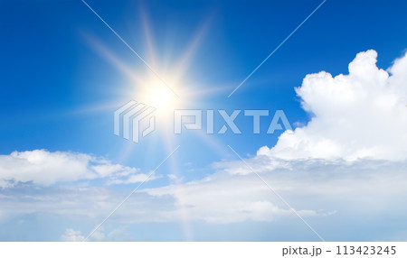 Bright sun on a blue sky. Wide photo. 113423245
