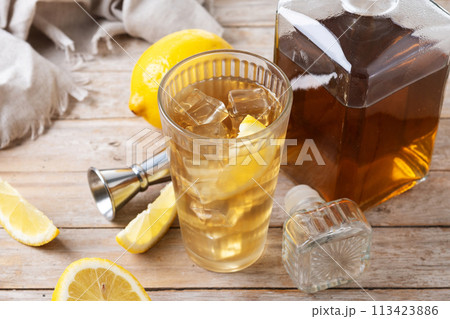 Highball, Whiskey with soda and lemon beverage on wooden table 113423886