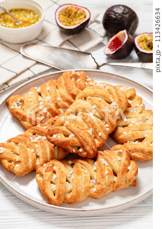 passion fruit puff pastry turnovers on a plate 113426634