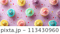 Flat lay of colorful pastel birthday cupcakes on a pastel background 113430960