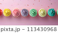 Flat lay of colorful birthday cupcakes on a pastel background, top view 113430968
