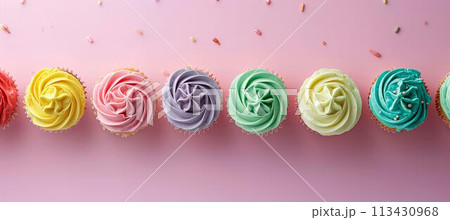 Flat lay of colorful birthday cupcakes on a pastel background, top view Flat lay of colorful birthday cupcakes on a pastel background, top view 113430968