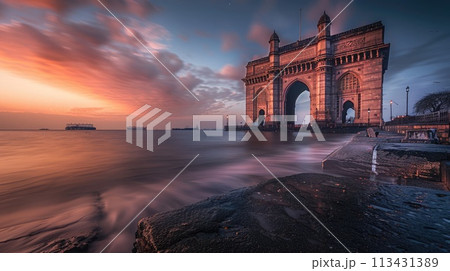 Mumbai. The stone arch of India's Gateway shines at sunrise with the Arabian Sea in view 113431389