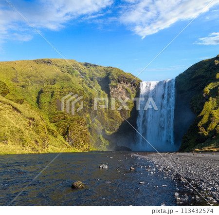 Picturesque full of water big waterfall Skogafoss autumn view, southwest Iceland. 113432574