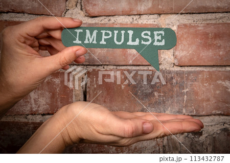 Impulse. Green speech bubble with text on a red brick background Impulse. Green speech bubble with text on a red brick background 113432787
