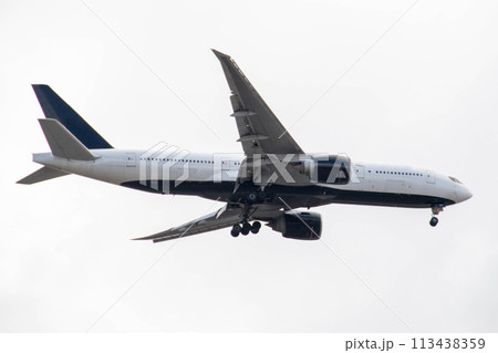 White passenger airplane flying in the sky amazing clouds in the background 113438359