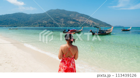 Sea travel,Woman standing at the beach by the clear sea on a tropical island Sea travel,Woman standing at the beach by the clear sea on a tropical island 113439126