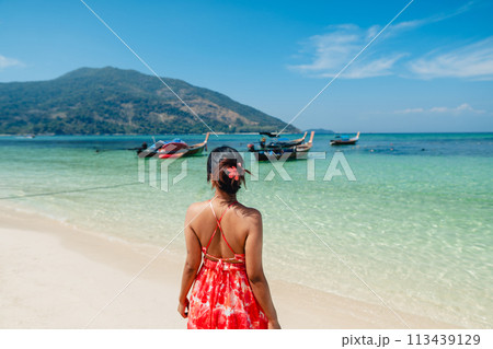 Sea travel,Woman standing at the beach by the clear sea on a tropical island Sea travel,Woman standing at the beach by the clear sea on a tropical island 113439129