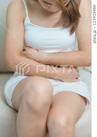 woman having abdomen ache due to Stomach pain, digestion with constipation or Diarrhea from food poisoning, female problem and Endometriosis, Hysterectomy, Stomachache and Menstrual on sofa at home woman having abdomen ache due to Stomach pain, digestion with constipation or Diarrhea from food poisoning, female problem and Endometriosis, Hysterectomy, Stomachache and Menstrual on sofa at home 113439460