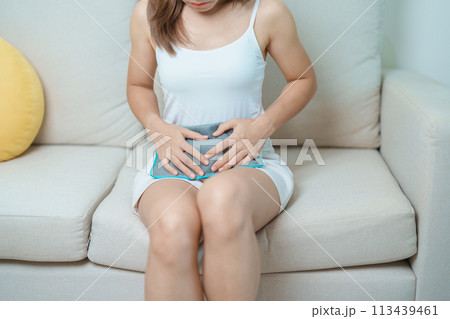 Menstruation period cycle of monthly and Stomachache concepts. woman having abdomen pain and menstrual ache with hot water bottle, illness female suffer from premenstrual ache and body Health problem Menstruation period cycle of monthly and Stomachache concepts. woman having abdomen pain and menstrual ache with hot water bottle, illness female suffer from premenstrual ache and body Health problem 113439461