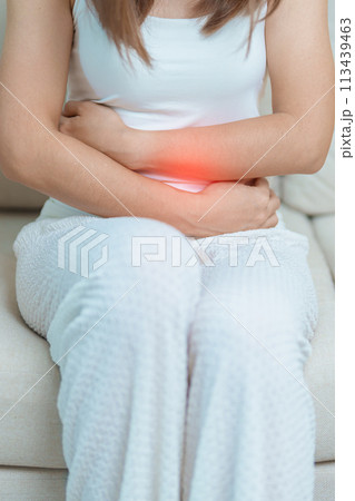 woman having abdomen ache due to Stomach pain, digestion with constipation or Diarrhea from food poisoning, female problem and Endometriosis, Hysterectomy, Stomachache and Menstrual on sofa at home woman having abdomen ache due to Stomach pain, digestion with constipation or Diarrhea from food poisoning, female problem and Endometriosis, Hysterectomy, Stomachache and Menstrual on sofa at home 113439463