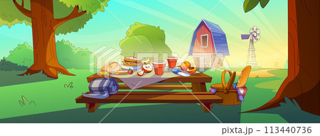 Picnic setup on outdoor table with rural red barn Picnic setup on outdoor table with rural red barn 113440736