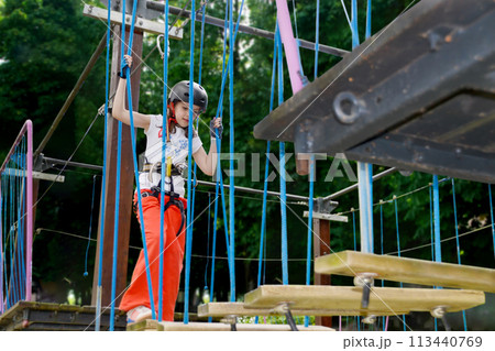 adventure climbing high wire park - people on course in mountain helmet 113440769