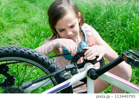 Young girl cyclist enjoy the beautiful sunrise on summer forest trail 113440795