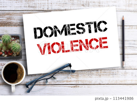 Business quotes, DOMESTIC VIOLENCE on notebooks or paper in office desk 113441986
