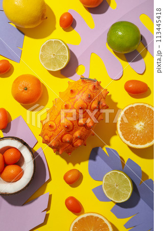 Set of tropical fruit and paper tropical leaves on yellow background, top view 113445418