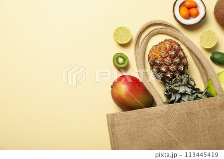 Set of tropical fruit in bag on beige background, space for text 113445419