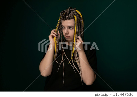 Woman With Dreadlocks Holding Hair in Front of Face 113447536
