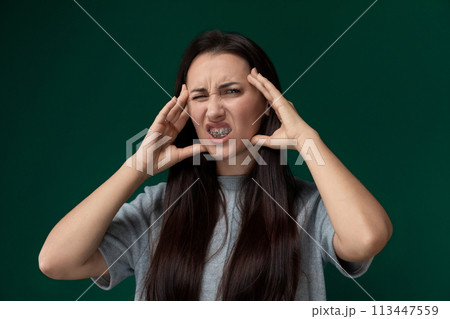 Woman Holding Hands to Ears 113447559
