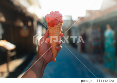 Eating ice cream in the streets of 113448128