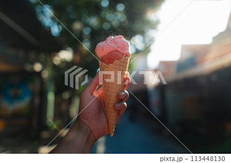 Eating ice cream in the streets of 113448130